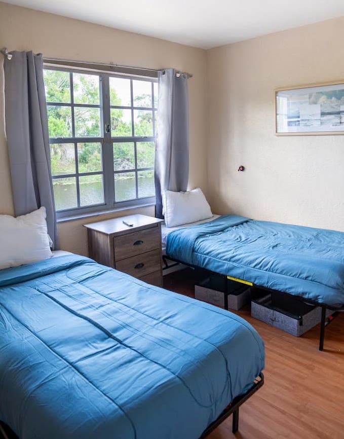 Comfortable waterfront bedroom in Port Charlotte Detox & Residential Treatment Center for addiction.